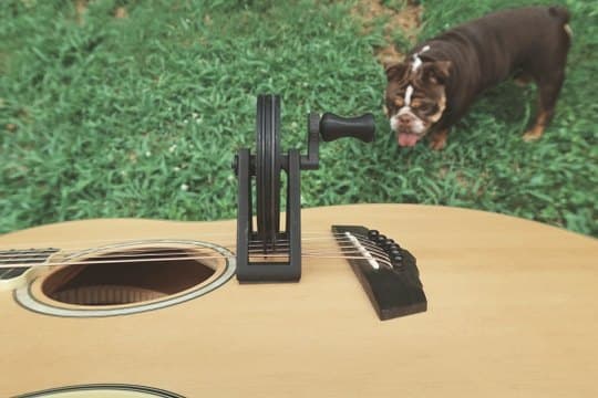 The spoked wheel seated between soundhole and bridge